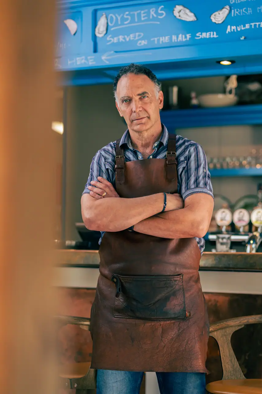 Tom Hale står foran baren i Tom’s Oyster Shack i København med fokus på bæredygtighed, fotograferet af Skovgaard & Damgaard.